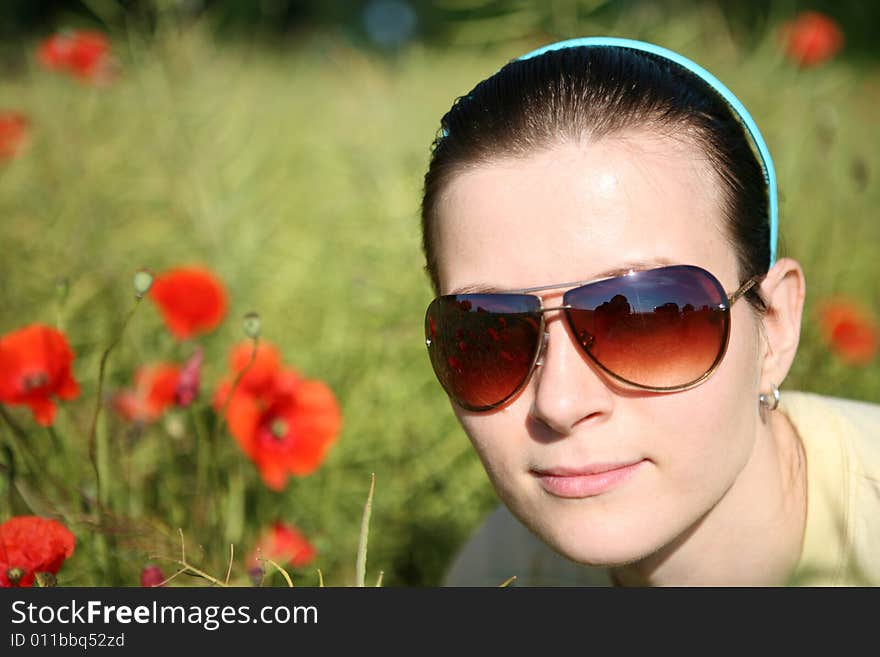 Smiling woman in poppy field