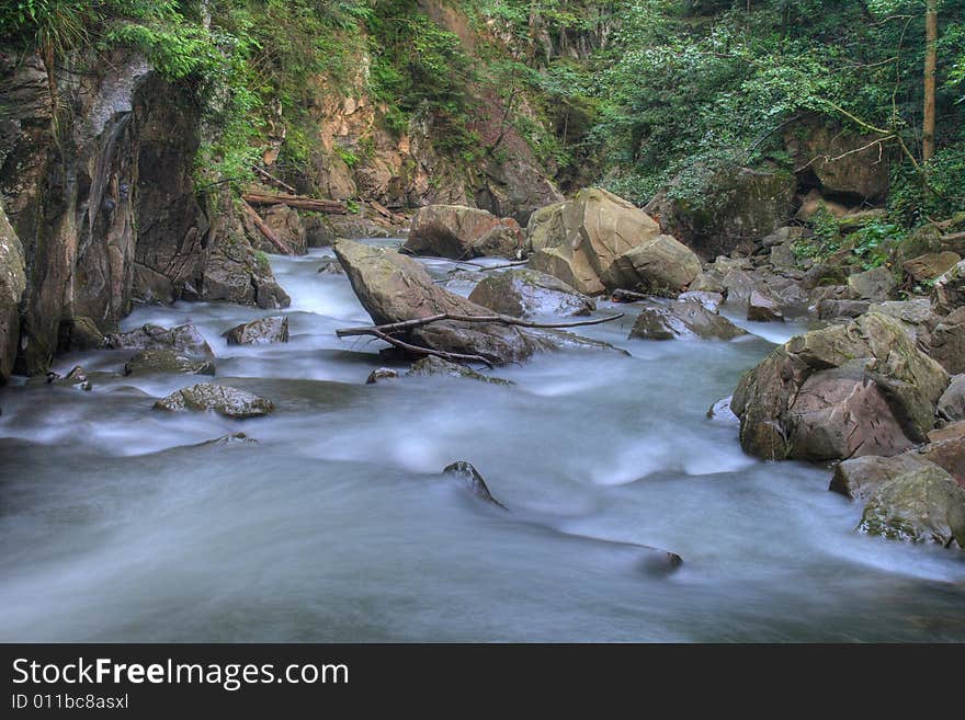 On a photo mountain river stone with moss. Ukraine