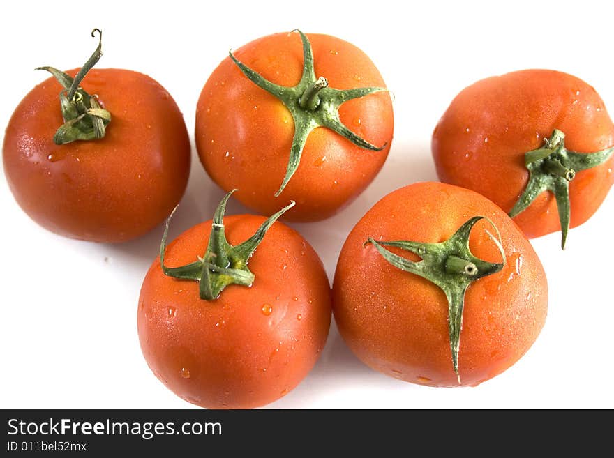 Five tomatoes on white background