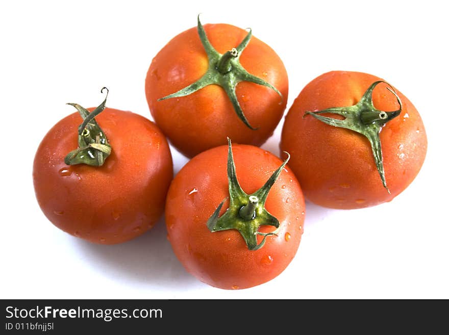 Four tomatoes on white background