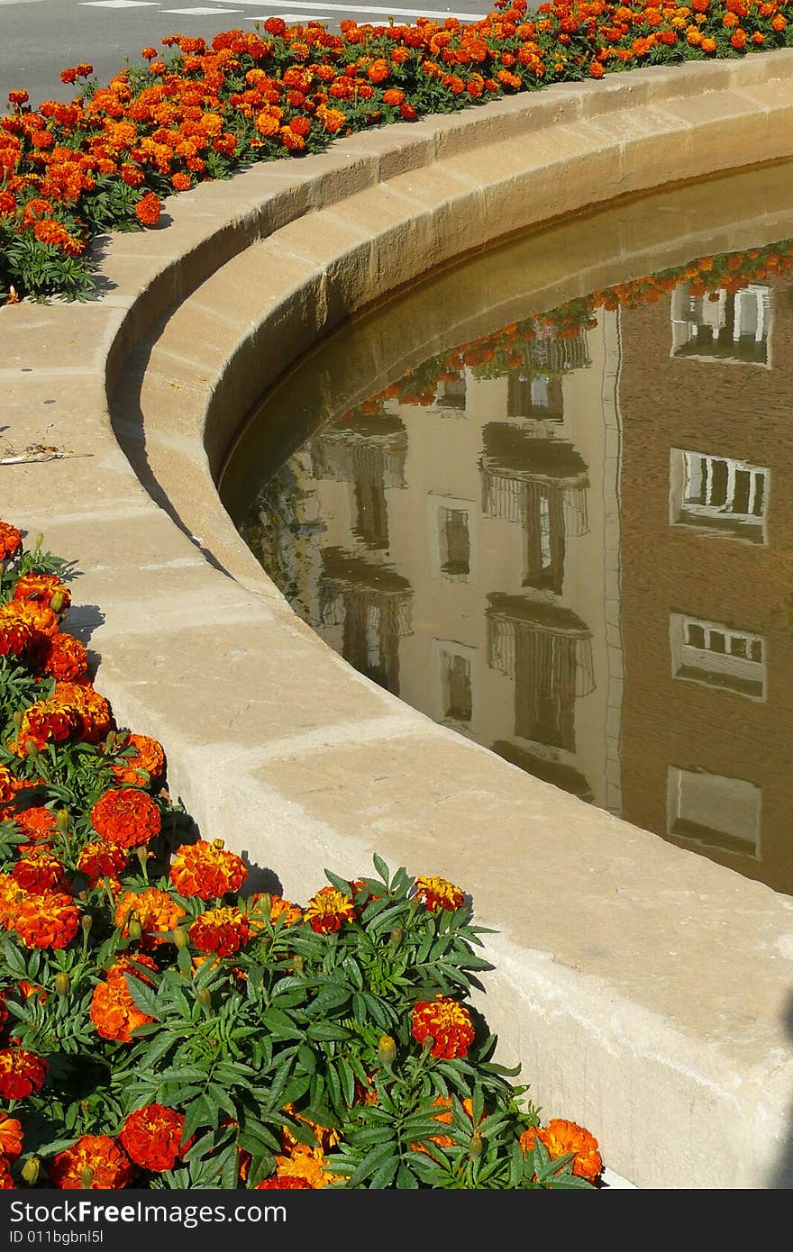 The houses are reflected on the fountain in Barcelona. The houses are reflected on the fountain in Barcelona