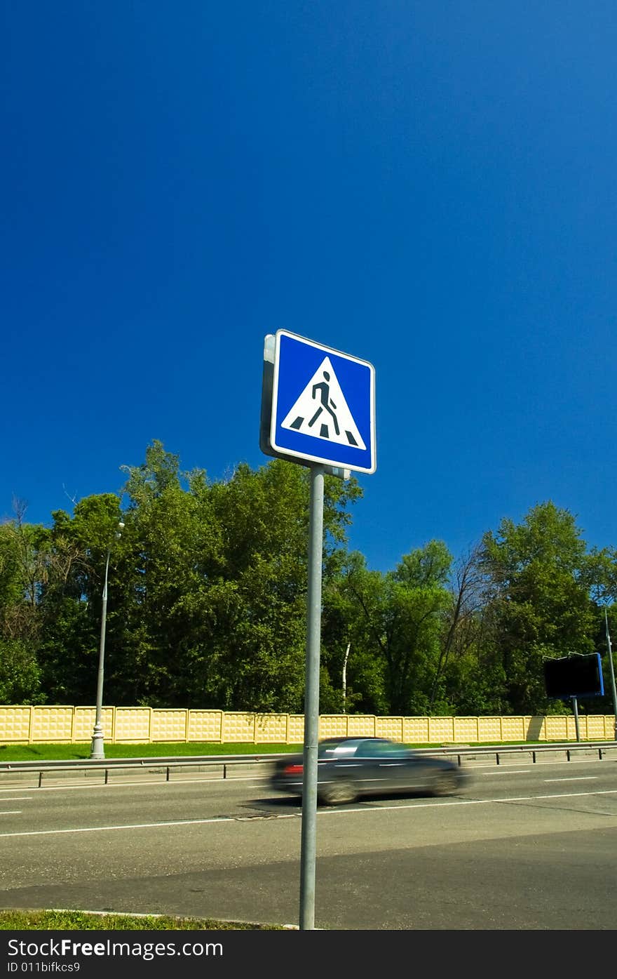 Pedestrian road sign passed by a car