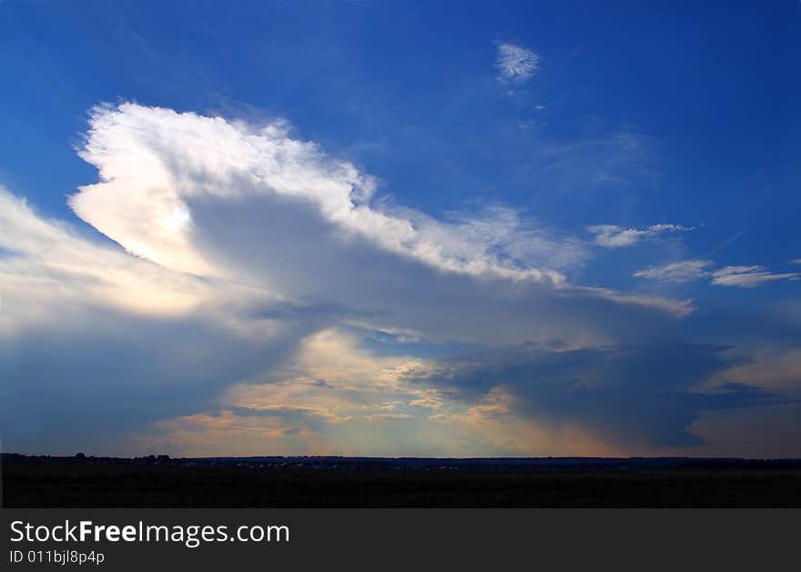 Raining clouds in blue sky on horizon. Raining clouds in blue sky on horizon