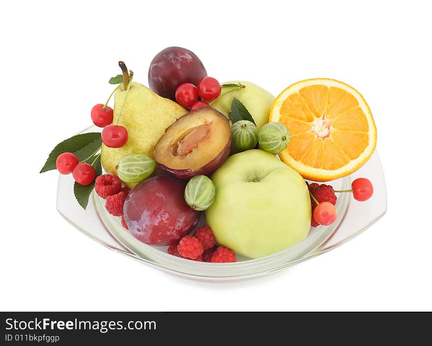 Fruit and berries lay on a glass plate. Fruit and berries lay on a glass plate