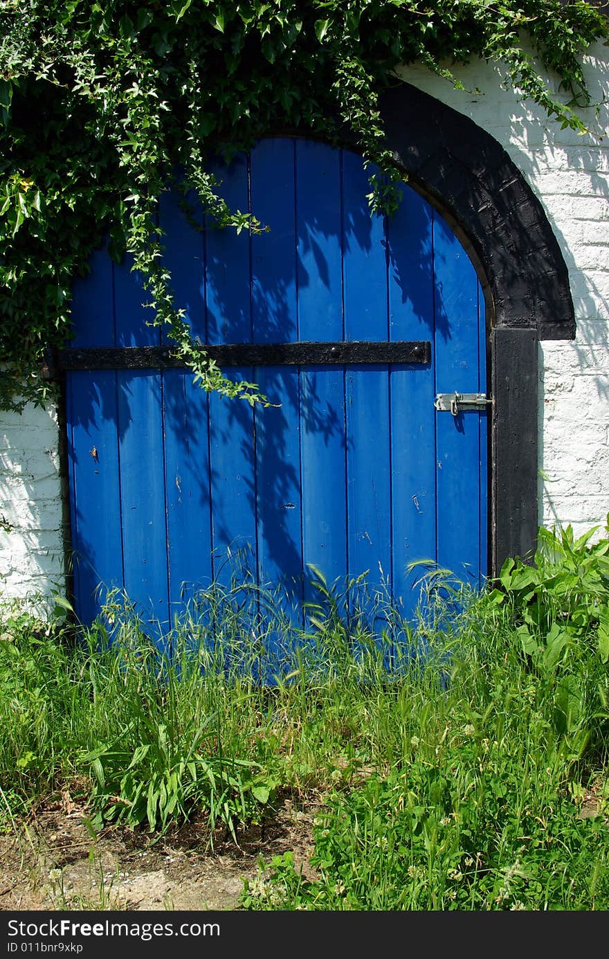 Detail view of a blue old door made of wood.