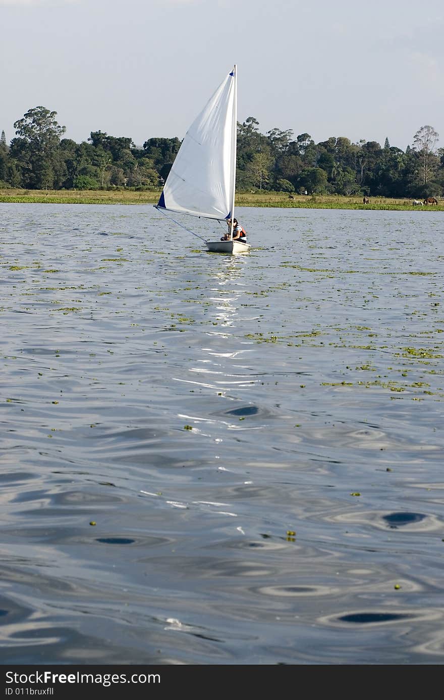 Couple Sailing Across Lake - Vertical