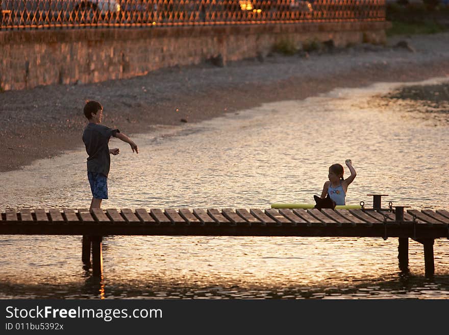 Boy and girl playing together in the lake