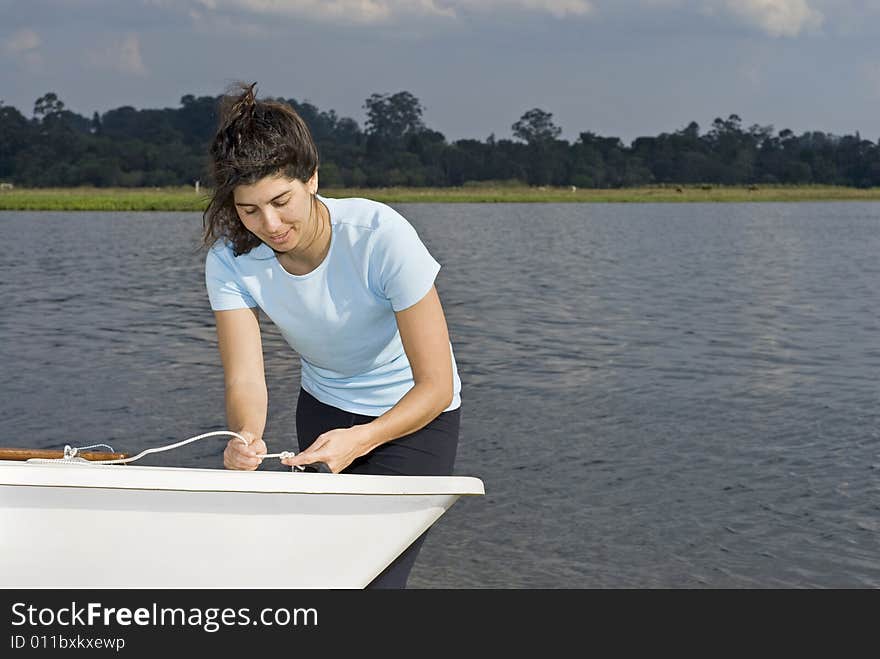 Woman Tying Knot in Rope on Boat - Horizontal