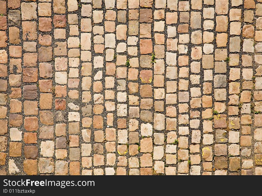 Stone design in Prague sidewalk. Background texture.