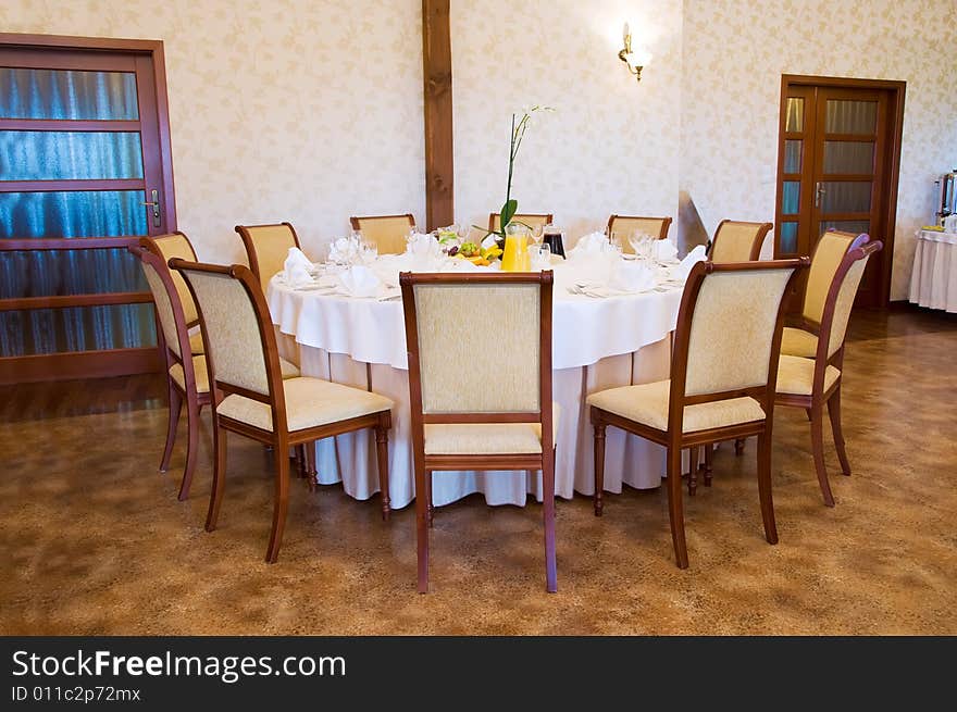 Round banquet table with chairs by door. Round banquet table with chairs by door