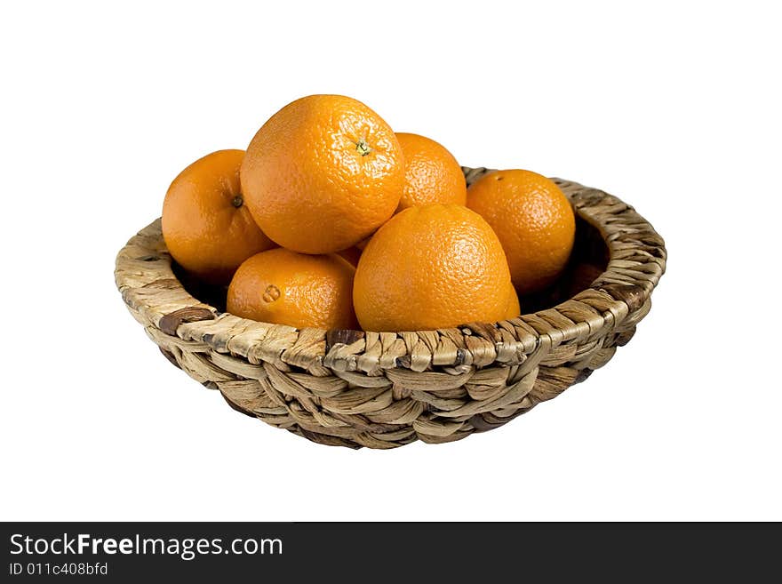 Oranges in basket are isolated on white background