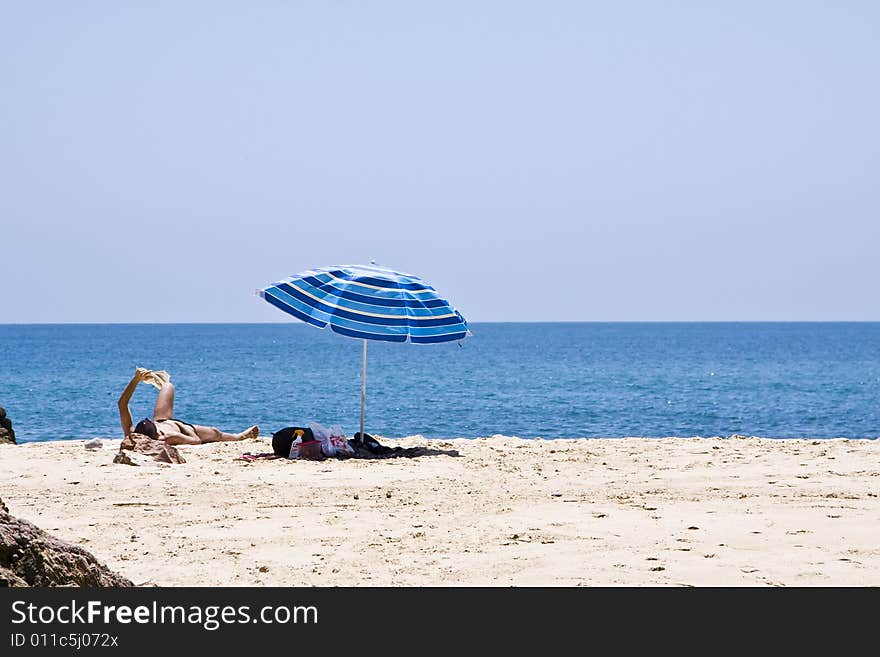 Man Reading In The Beach