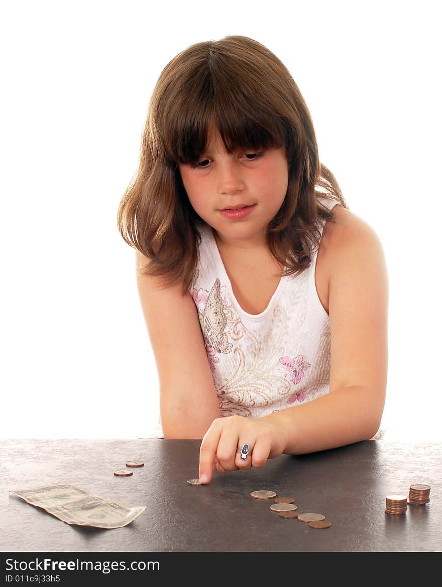 An elementary girl counting her pennies and quarters and dollar. An elementary girl counting her pennies and quarters and dollar.