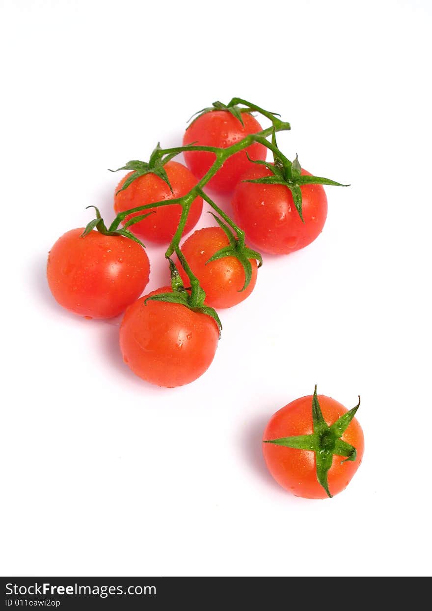 Cherry tomatoes together and one of that is alone, on a white background