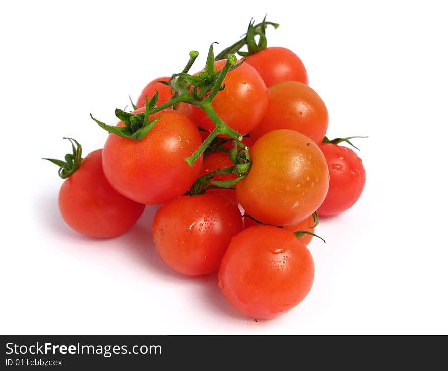 Cherry tomatoes together into a pyramid  on a white background