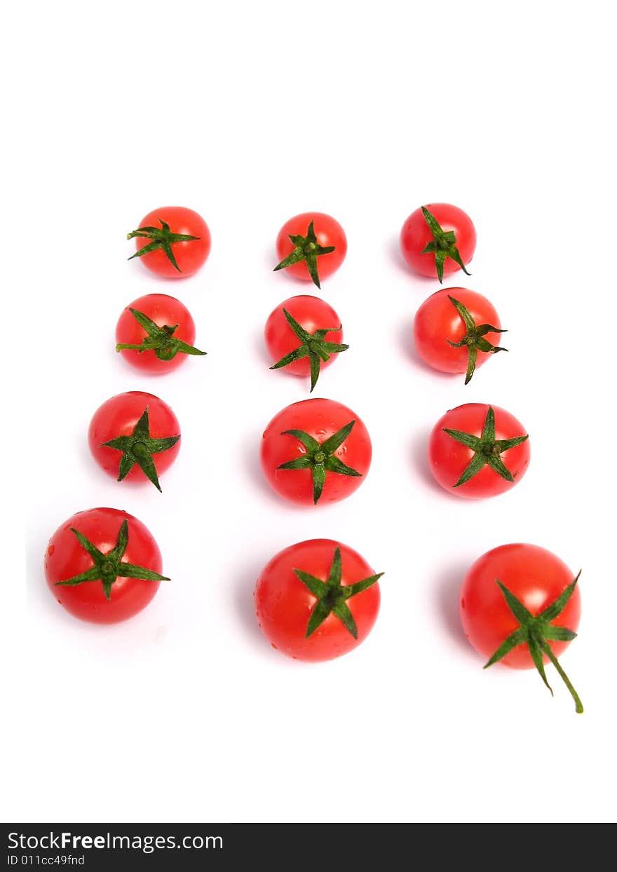 Cherry tomatoes together forming a line on a white background