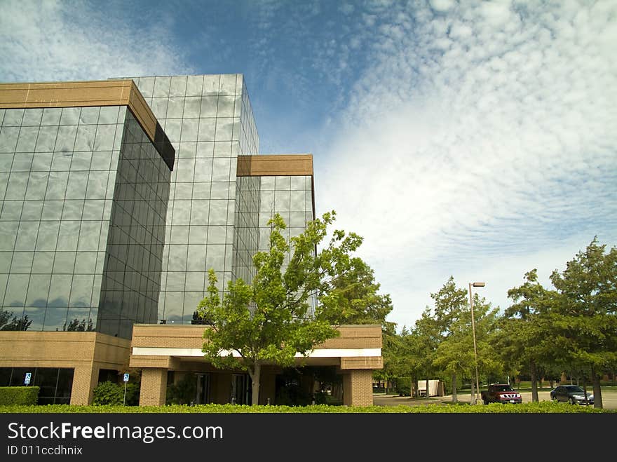 A sky with interesting cloud formations making interesting reflections in a glass building. A sky with interesting cloud formations making interesting reflections in a glass building.