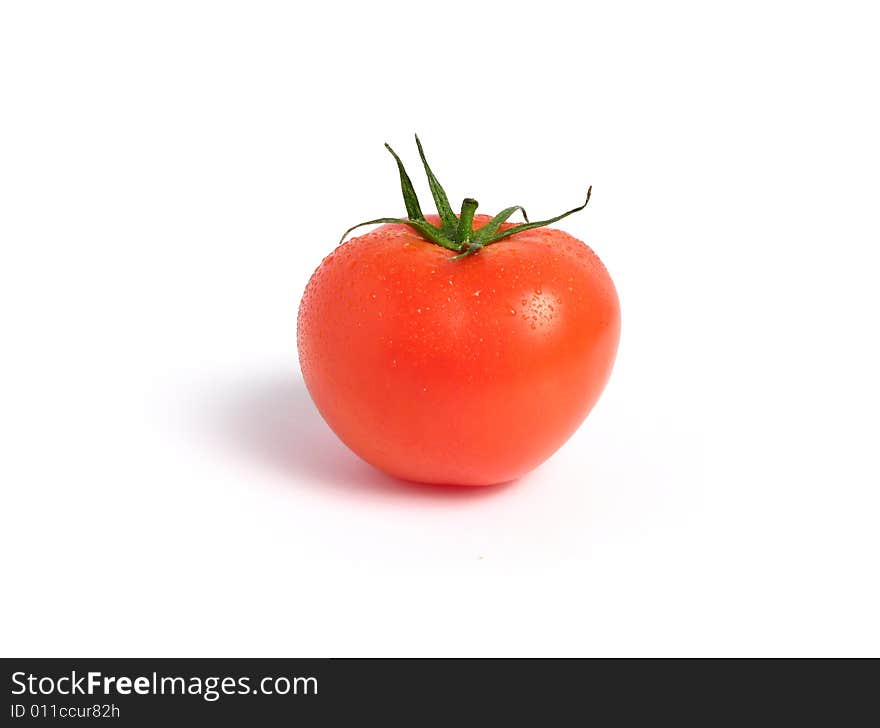 Tomato alone and wet on a white background. Tomato alone and wet on a white background