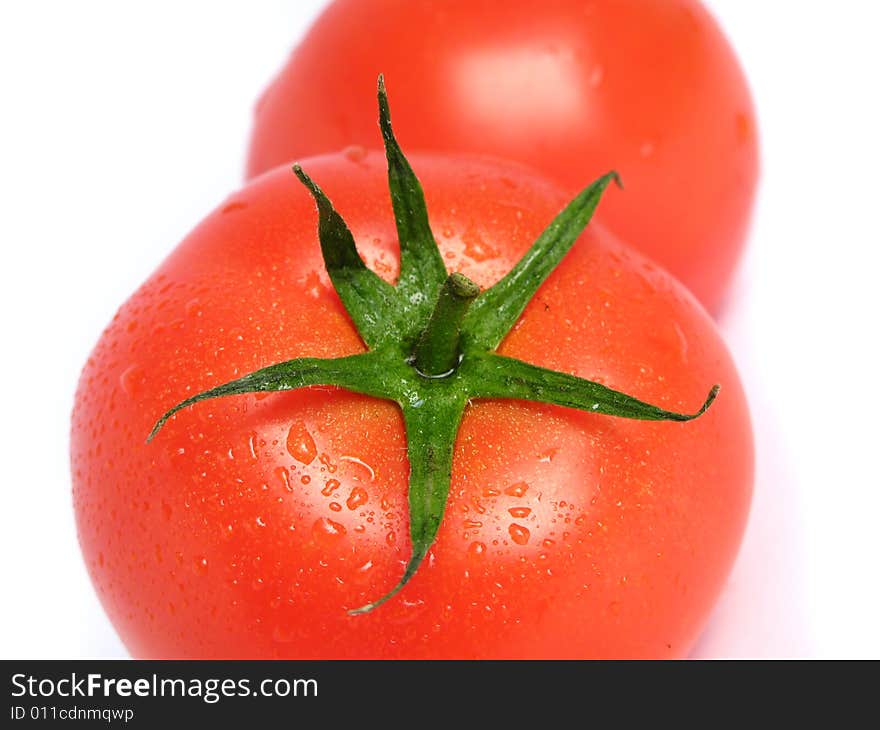 Wet tomatoes on a white background