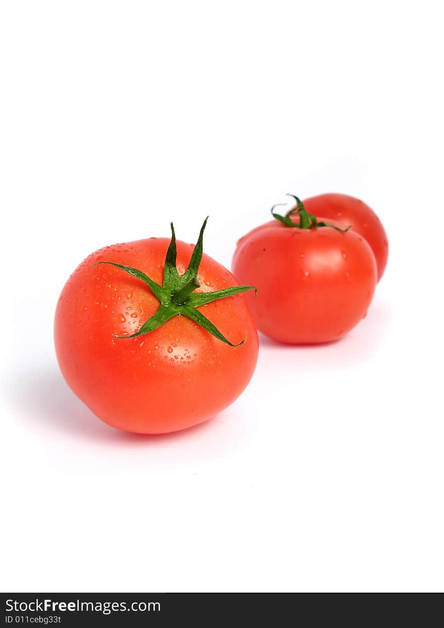 Wet tomatoes on a white background