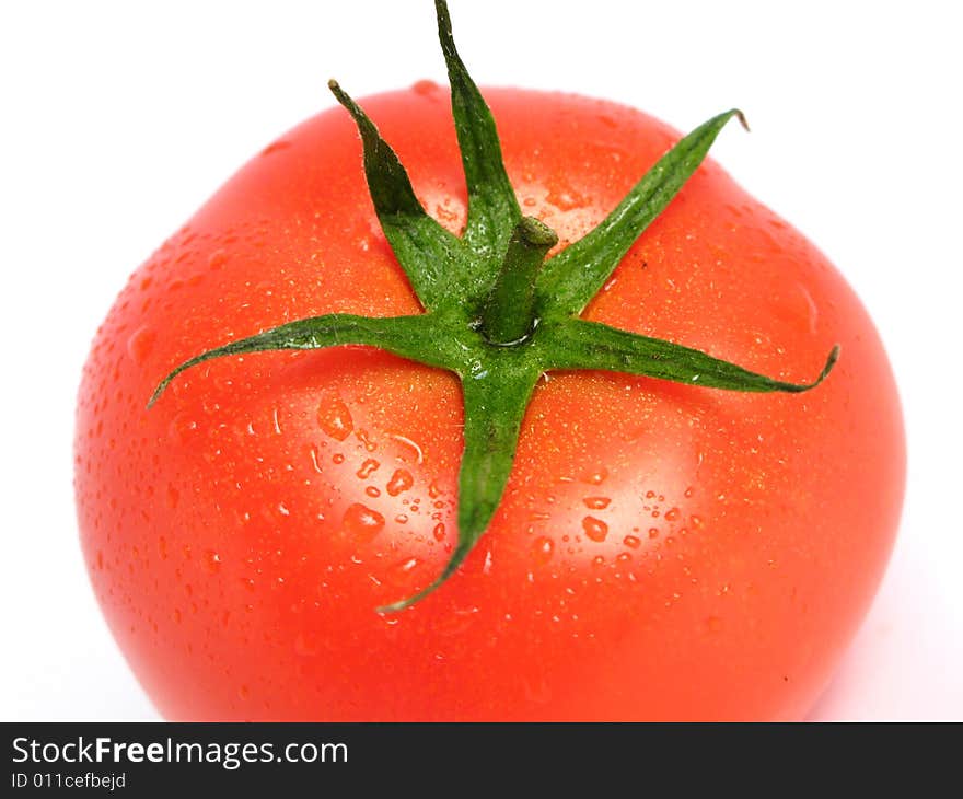 Tomato alone and wet on a white background. Tomato alone and wet on a white background