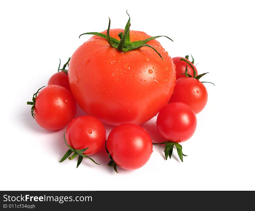 Tomato like a queen and cherry tomatoes together on a white background. Tomato like a queen and cherry tomatoes together on a white background