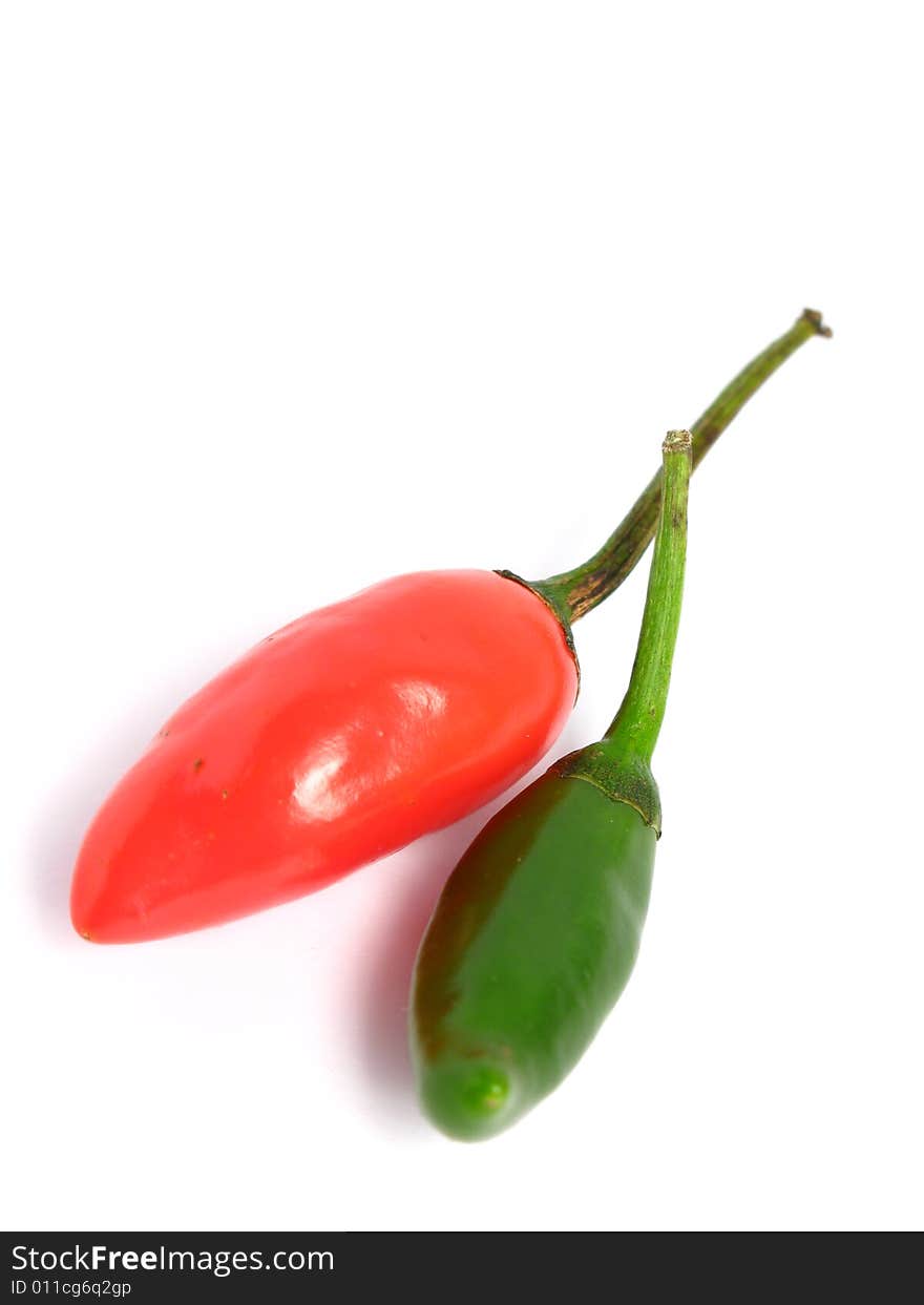 Two colors chilies couple on white background