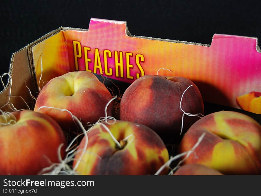 Fresh peaches shipped in a cardboard box. Fresh peaches shipped in a cardboard box.