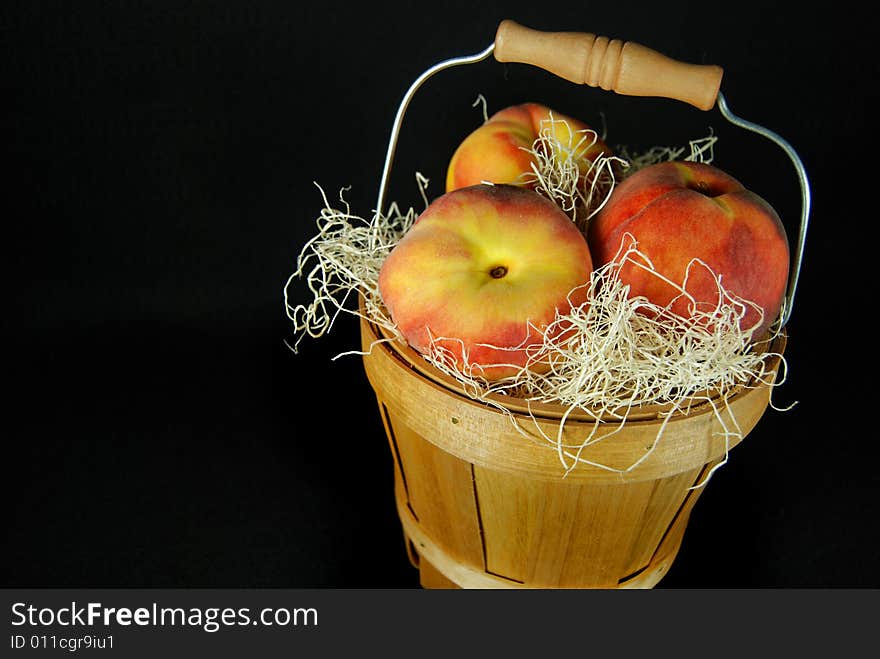 Fresh peaches in a bushel basket. Fresh peaches in a bushel basket.