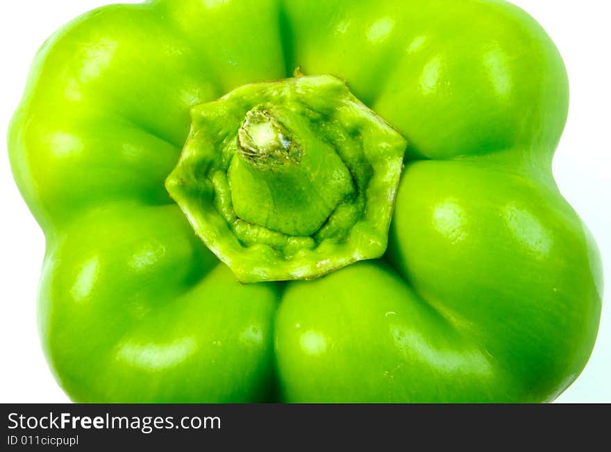 A closeup photograph of a bell pepper against a white background. A closeup photograph of a bell pepper against a white background