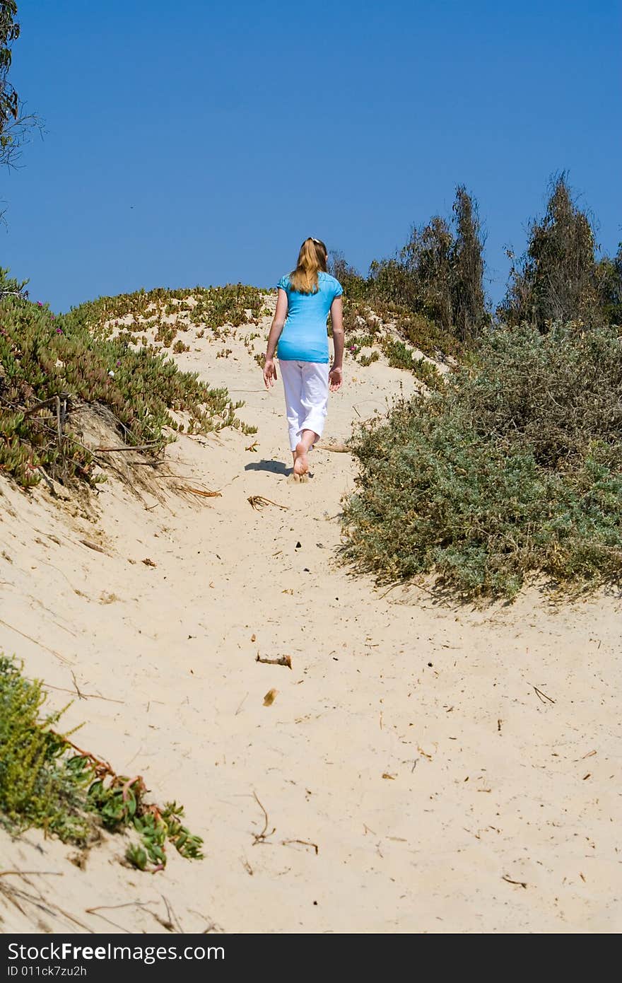 Teen Girl Walking up Sand Dune