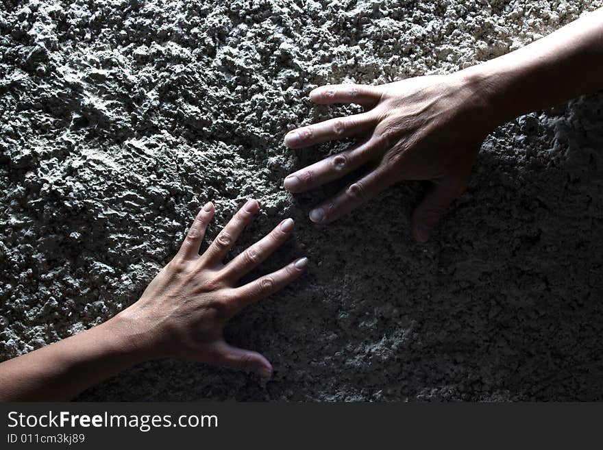 Hand on stone wall