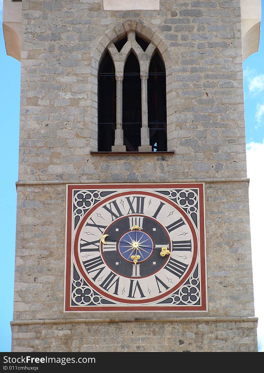 Details of the clock and the window of the Bressanone belltower. Details of the clock and the window of the Bressanone belltower