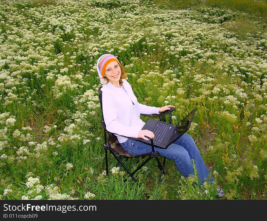 Girl with laptop outdoors.