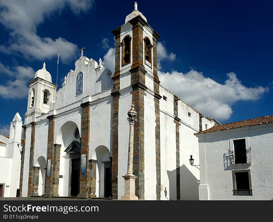 Portugal, Alentejo: Magnificent village of Monsaraz; view of the white houses and the white typical church. Portugal, Alentejo: Magnificent village of Monsaraz; view of the white houses and the white typical church