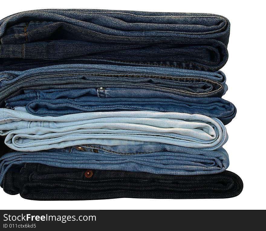 Stack of blue and black jeans over white with clipping path. Stack of blue and black jeans over white with clipping path