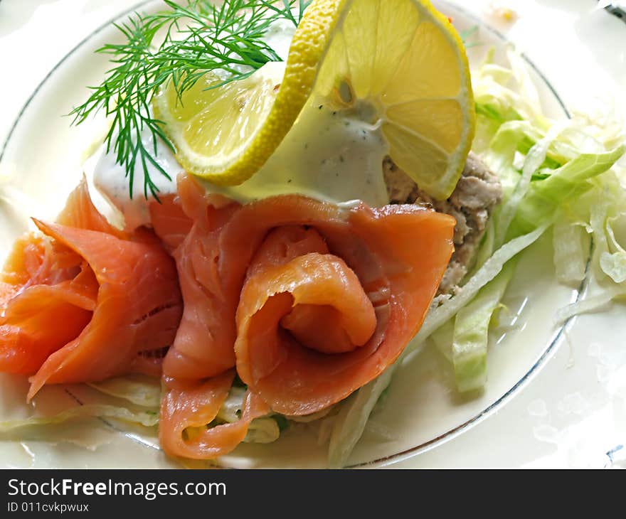 Fresh smoked salmon served with sauce and dill. Fresh smoked salmon served with sauce and dill