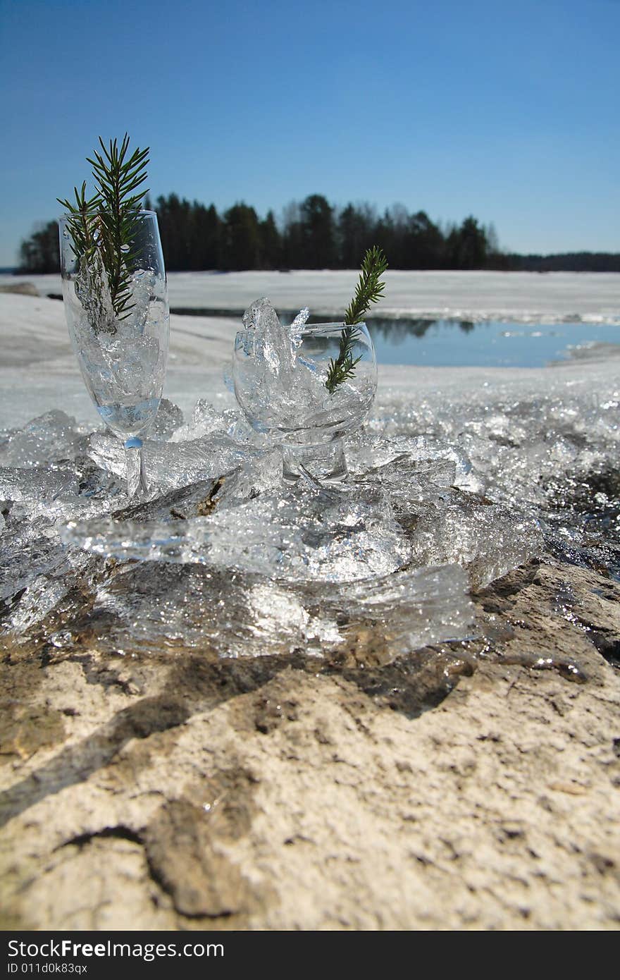 Glasses with ice on the edge of a frozen lake