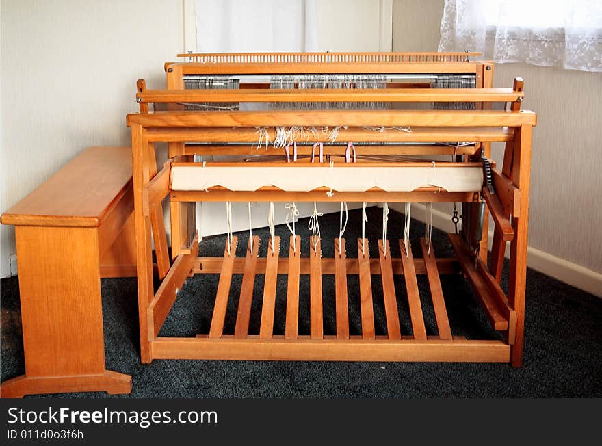 An old weaving loom shot from the users side, with the bench moved to allow a view of the pedals. An old weaving loom shot from the users side, with the bench moved to allow a view of the pedals