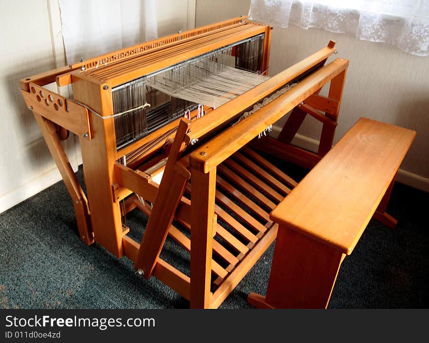 A view of an old weaving loom from the top and side