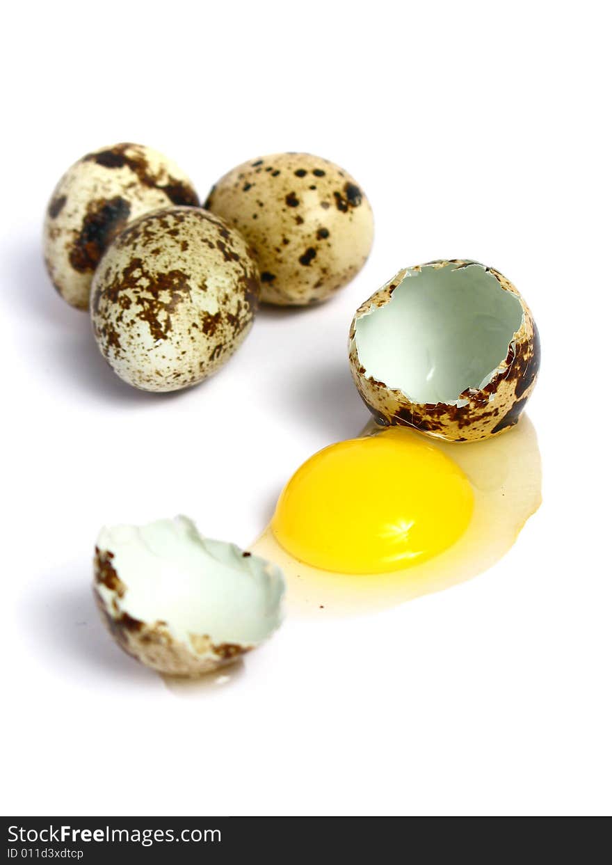 Quail Eggs broken and three more on group, on white background. Quail Eggs broken and three more on group, on white background