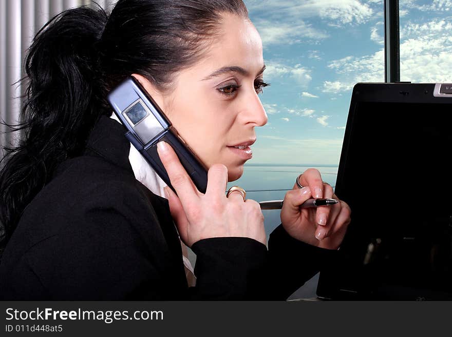 Pretty women ansering the phone at work. Pretty women ansering the phone at work