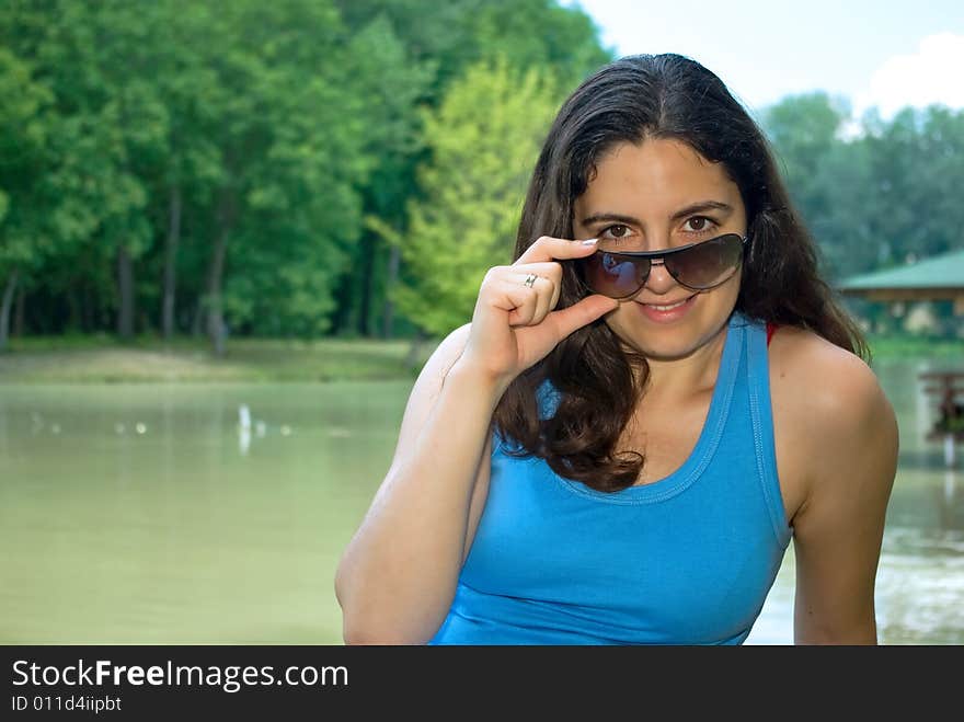 Pretty Girl In Sunglasses Looking And Smiling