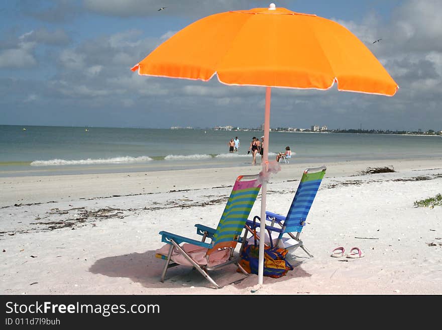 Bright Umbrella And Sun Chairs On The  Beach