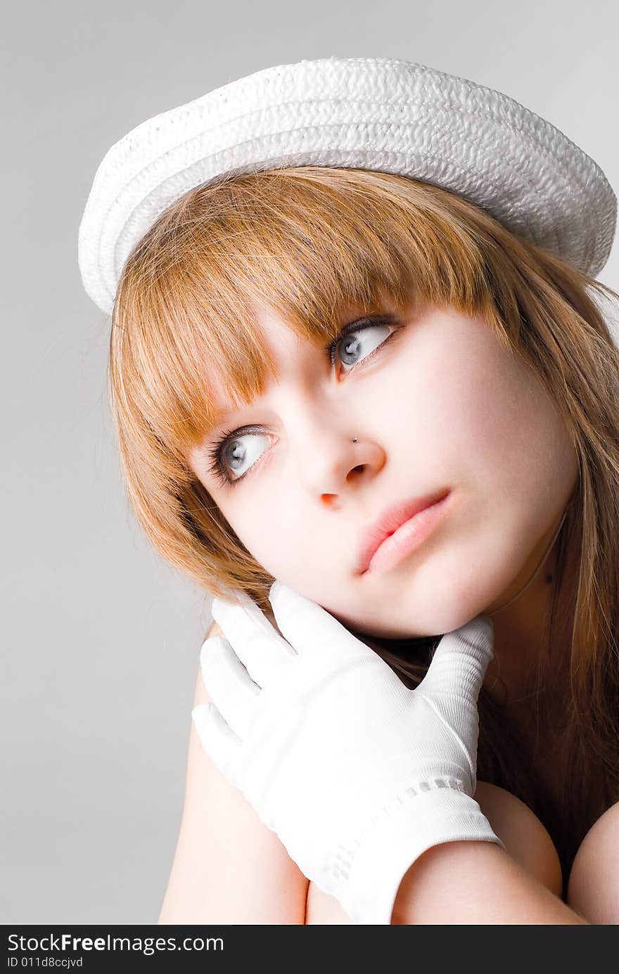 Beautiful dreaming girl in white hat and gloves. Beautiful dreaming girl in white hat and gloves