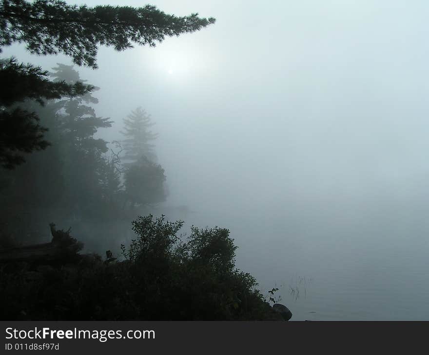 Foggy mist over lake in Adirondacks as the sun rises.