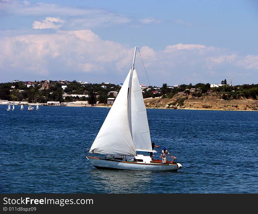 Beautiful sailing yacht with two people abord. Beautiful sailing yacht with two people abord