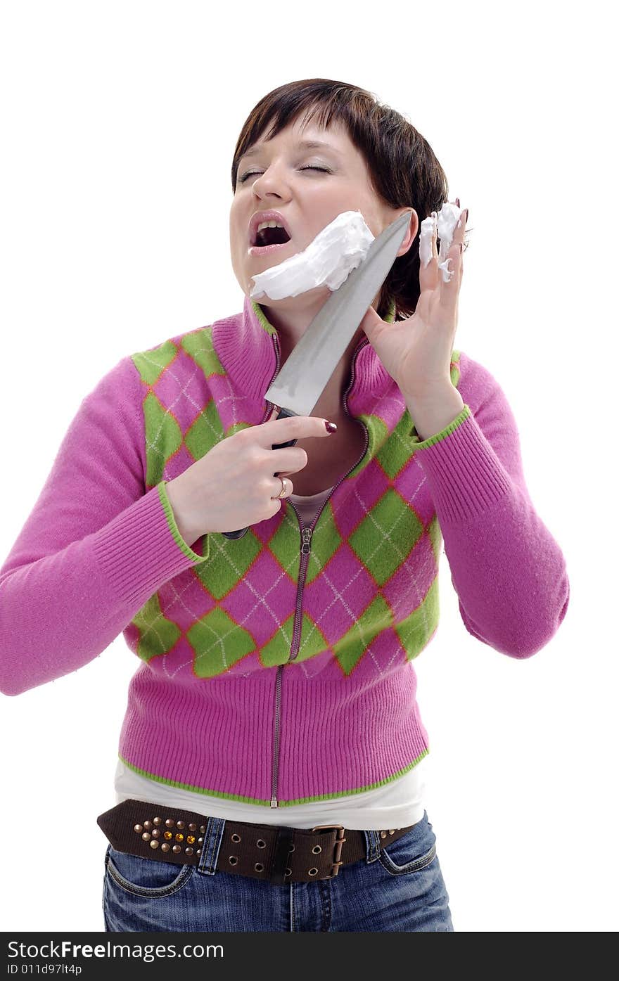 Young woman with knife and foam on her face