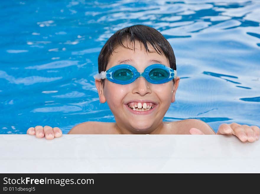 Boy Swimming In The Pool With Goggles