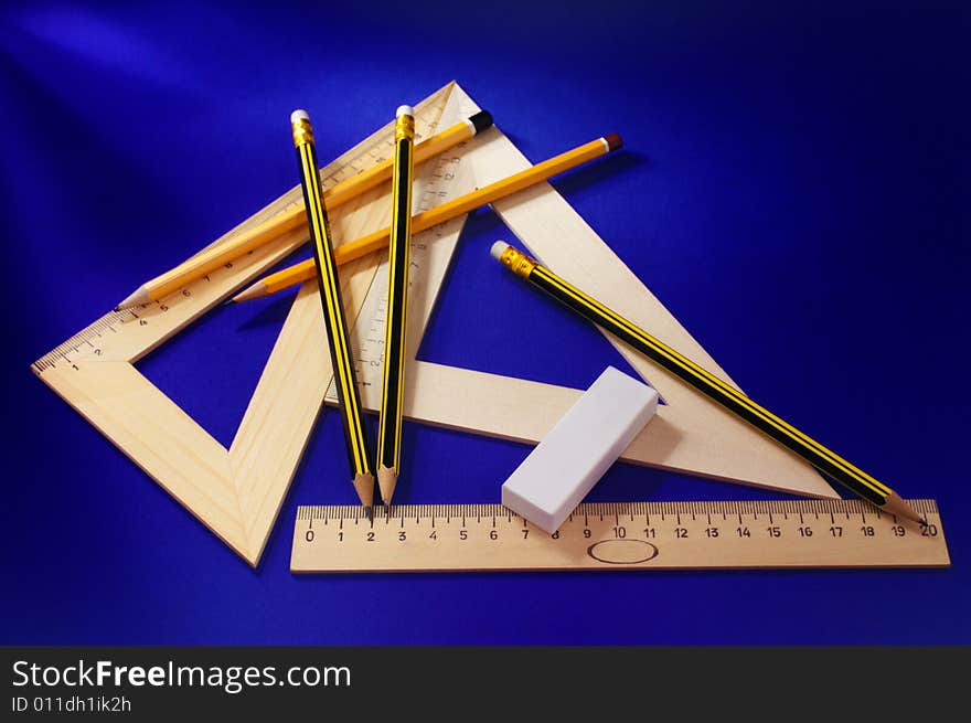 Measuring devices and a pencil  (on a dark blue background)